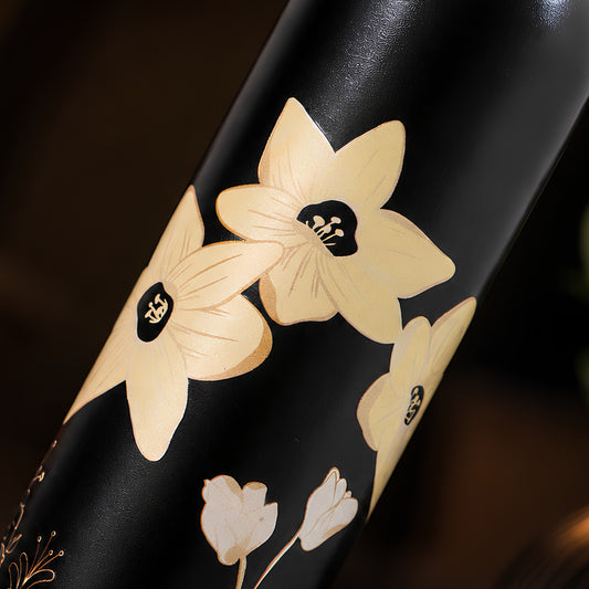 Creme floral UV embossed pattern closeup on Tamrit green copper bottle