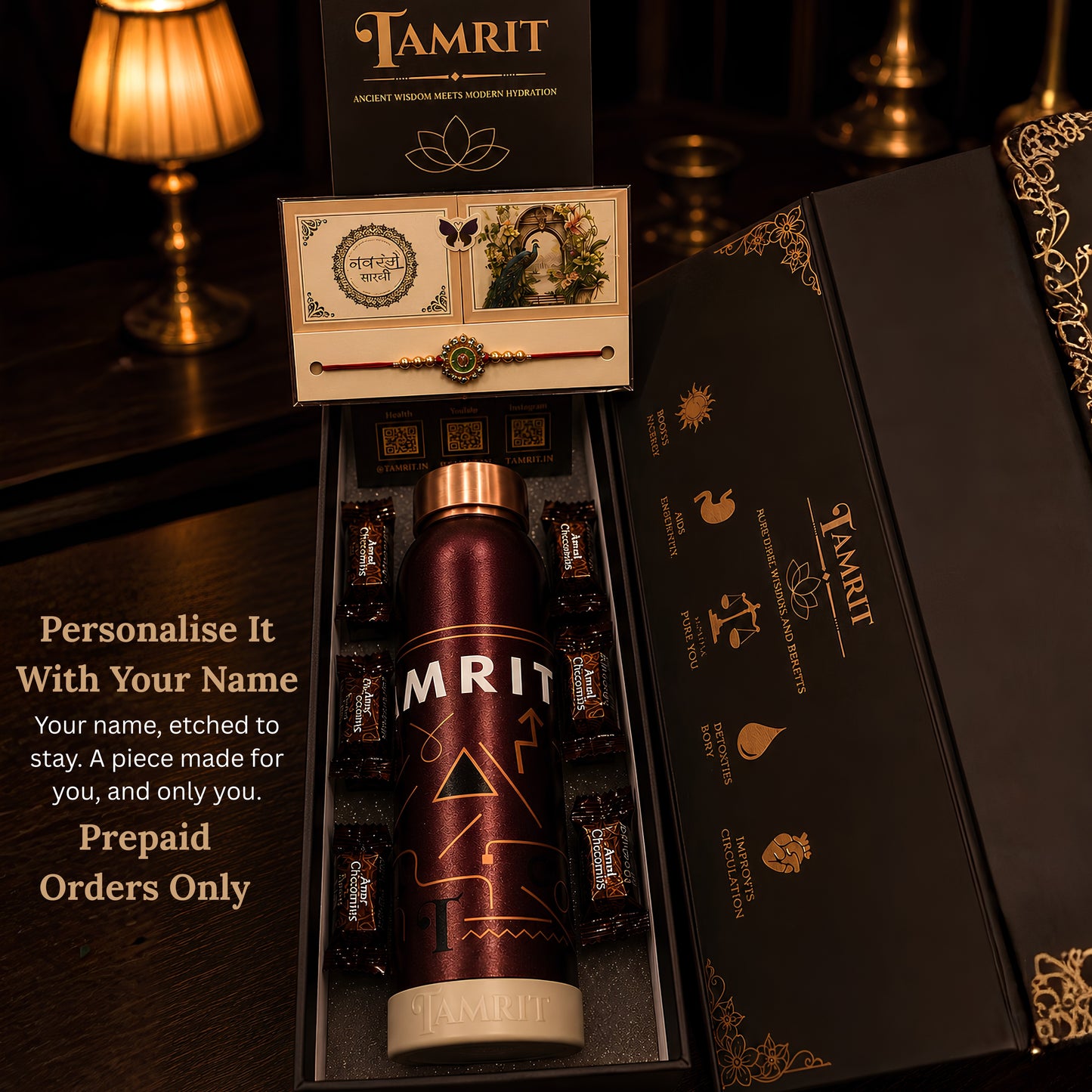 4. Open Tamrit gift box showing 1 Litre copper bottle with Amul chocolates and rakhi arranged inside
