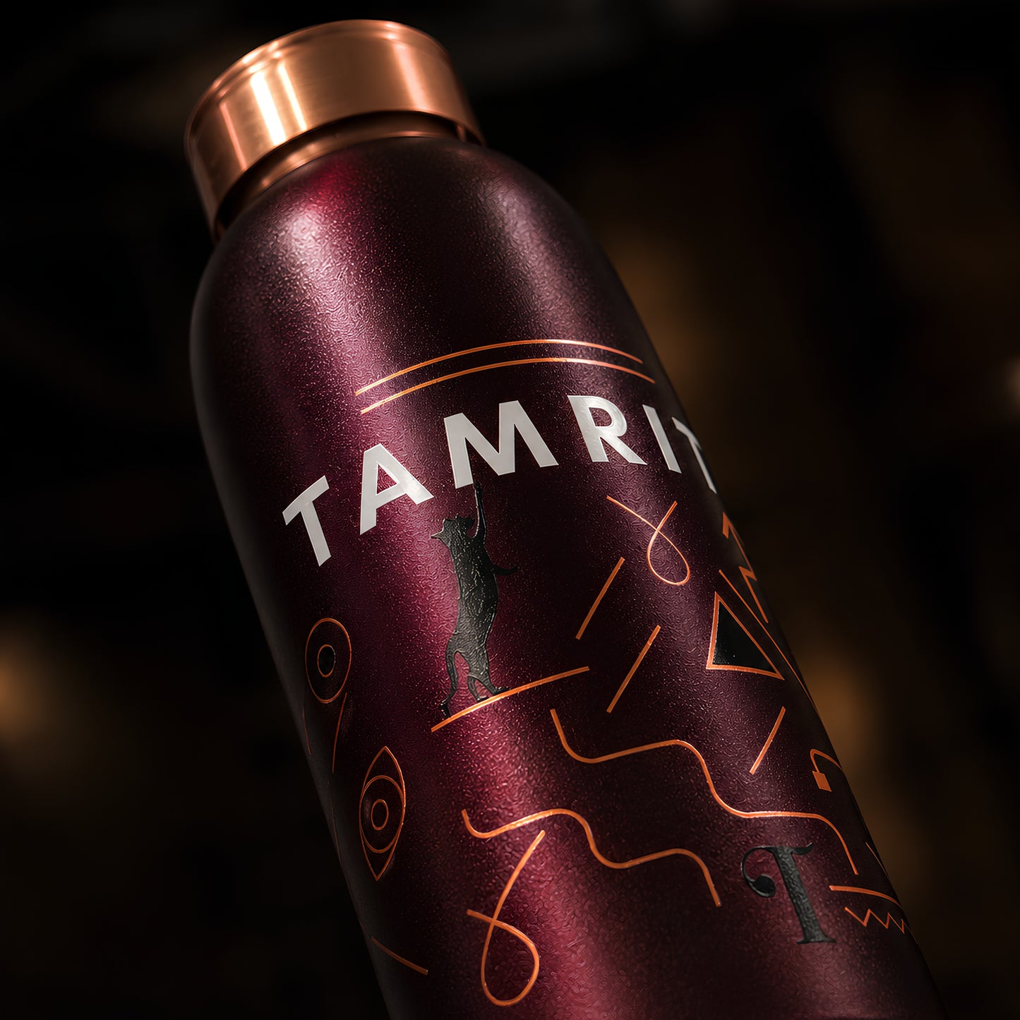 Amrit wordmark and geometric UV embossed pattern on Tamrit copper bottle