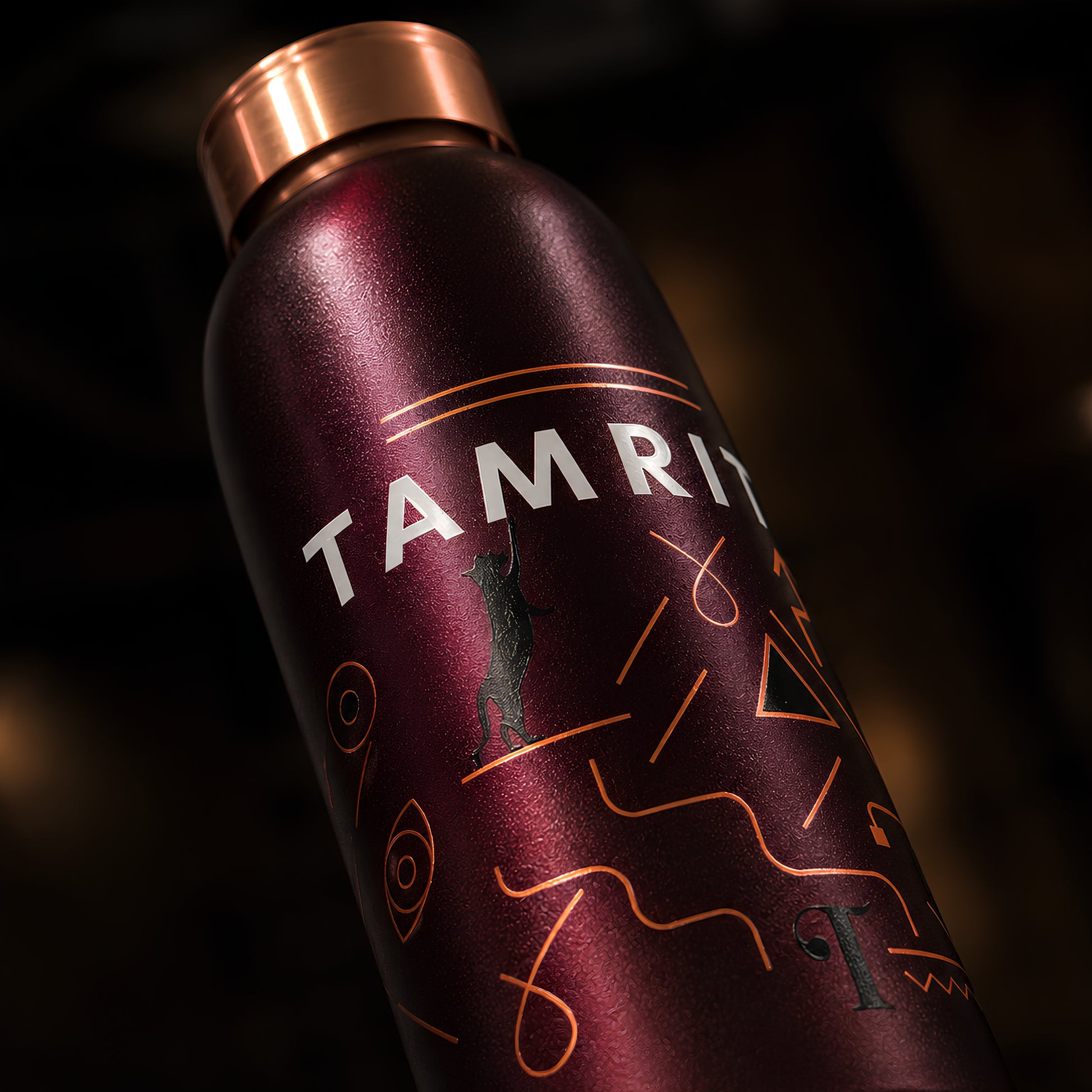 Amrit wordmark and geometric UV embossed pattern on Tamrit copper bottle