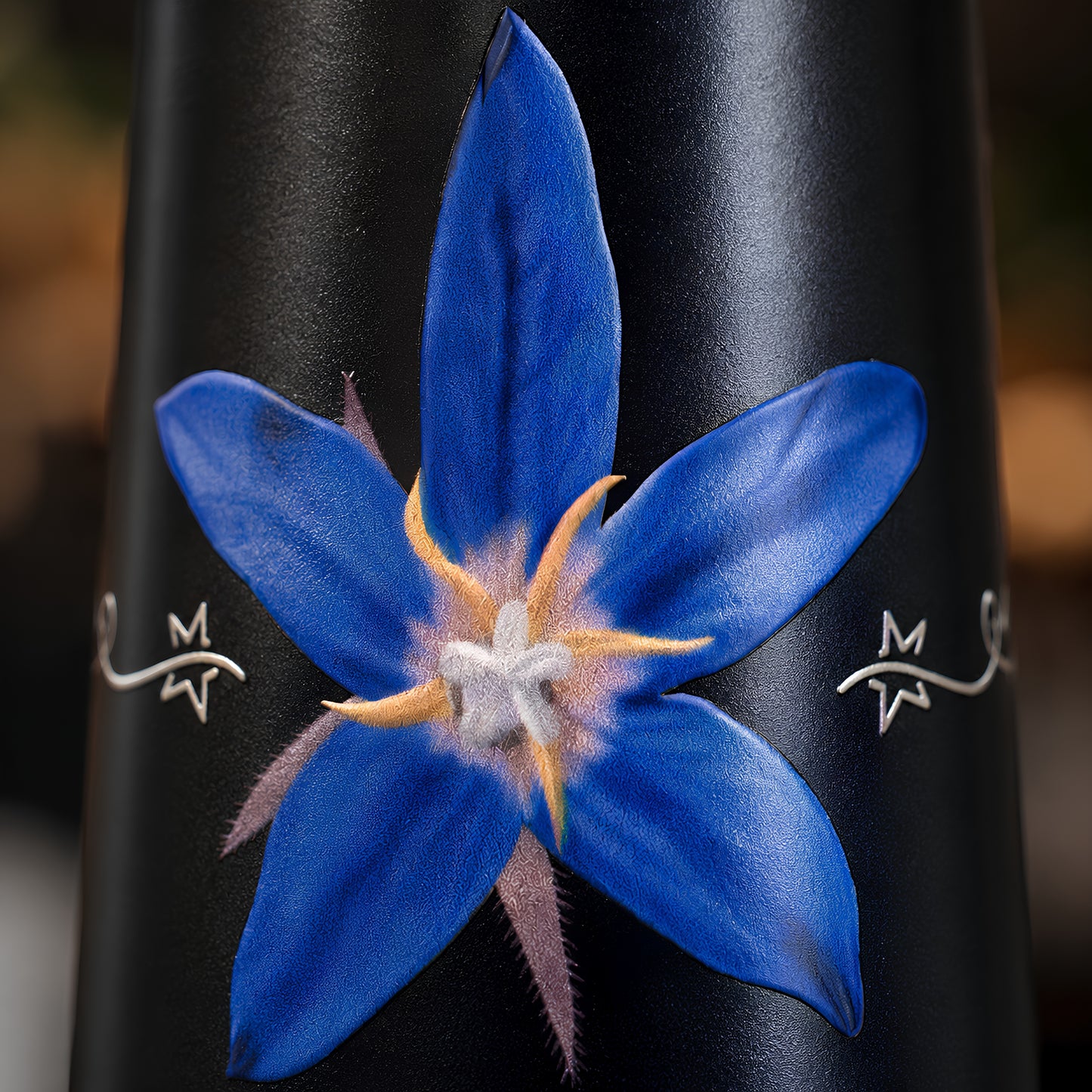 White star flower UV embossed design closeup on Tamrit blue copper bottle