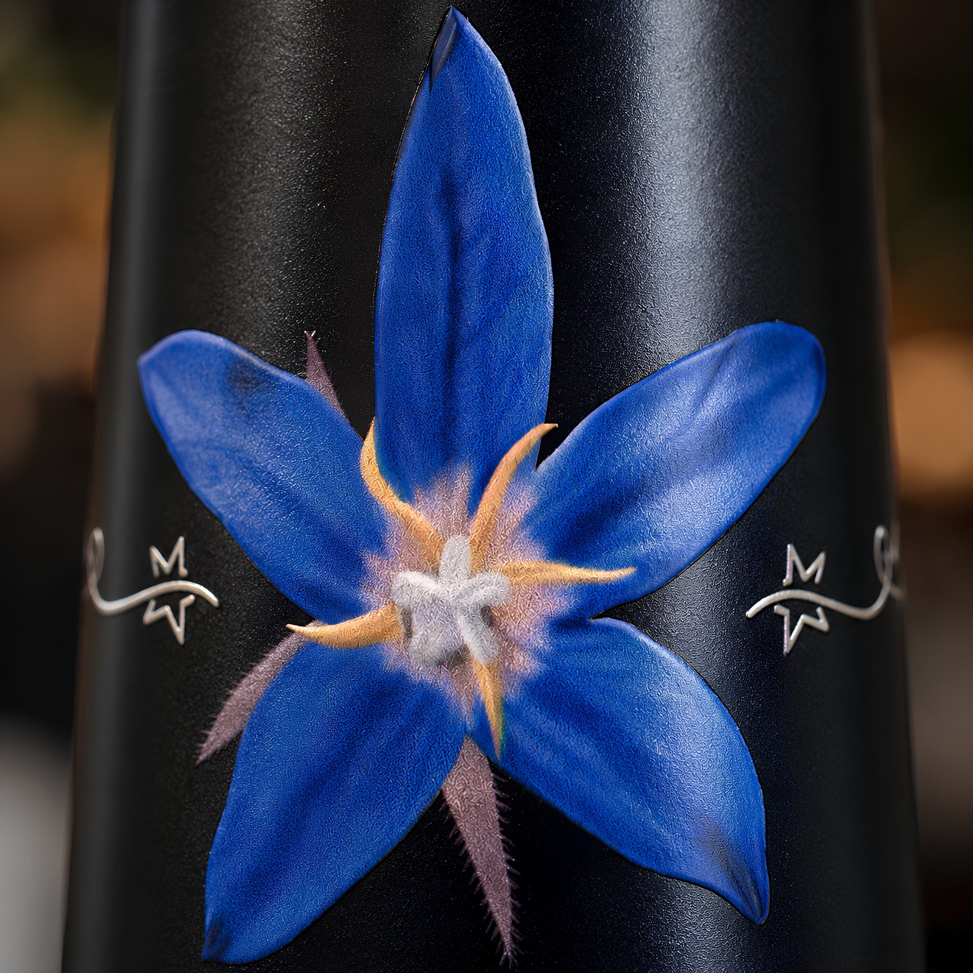 White star flower UV embossed design closeup on Tamrit blue copper bottle
